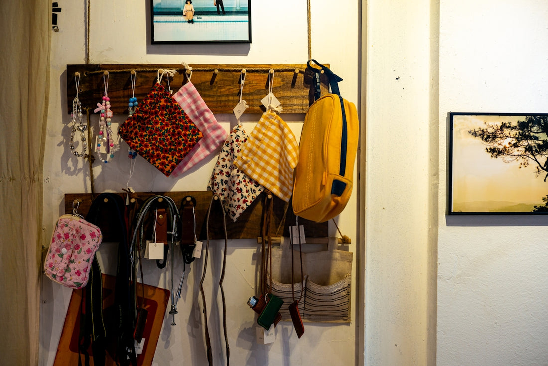 Handbags and other items hang on a wooden rack.