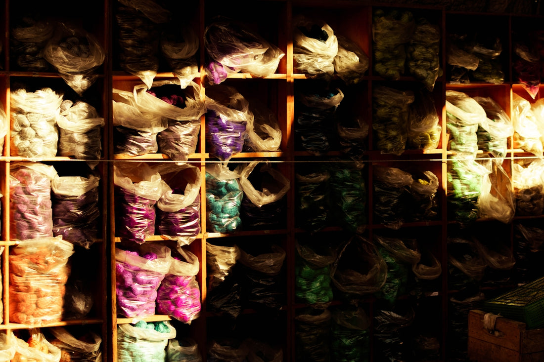 a display case filled with lots of different colored bags