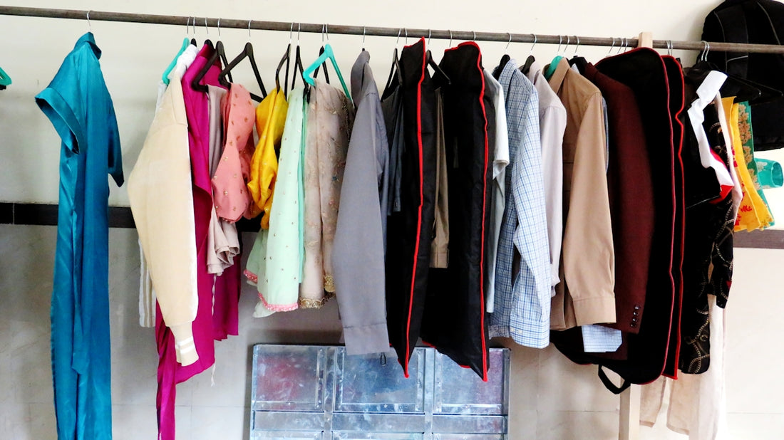 a bunch of clothes hanging on a clothes rack