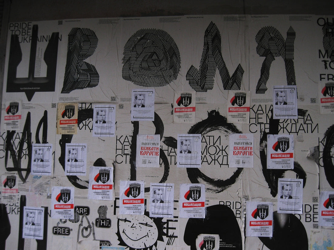 A wall covered in lots of different types of graffiti