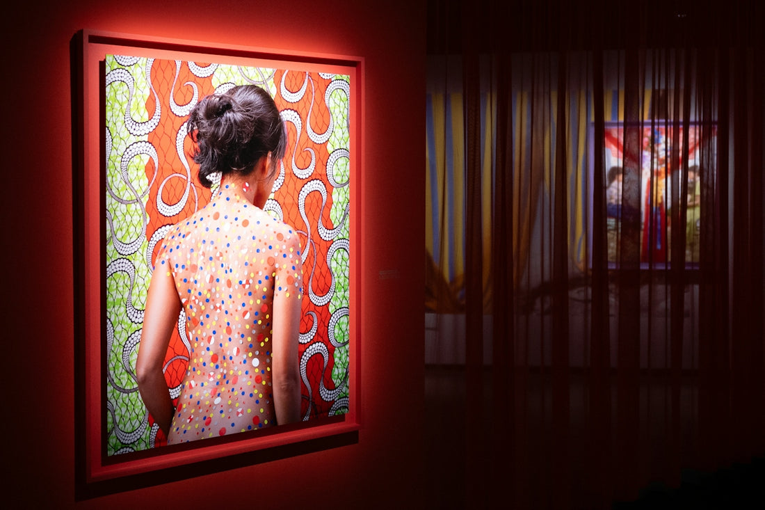 A woman views artwork in a gallery