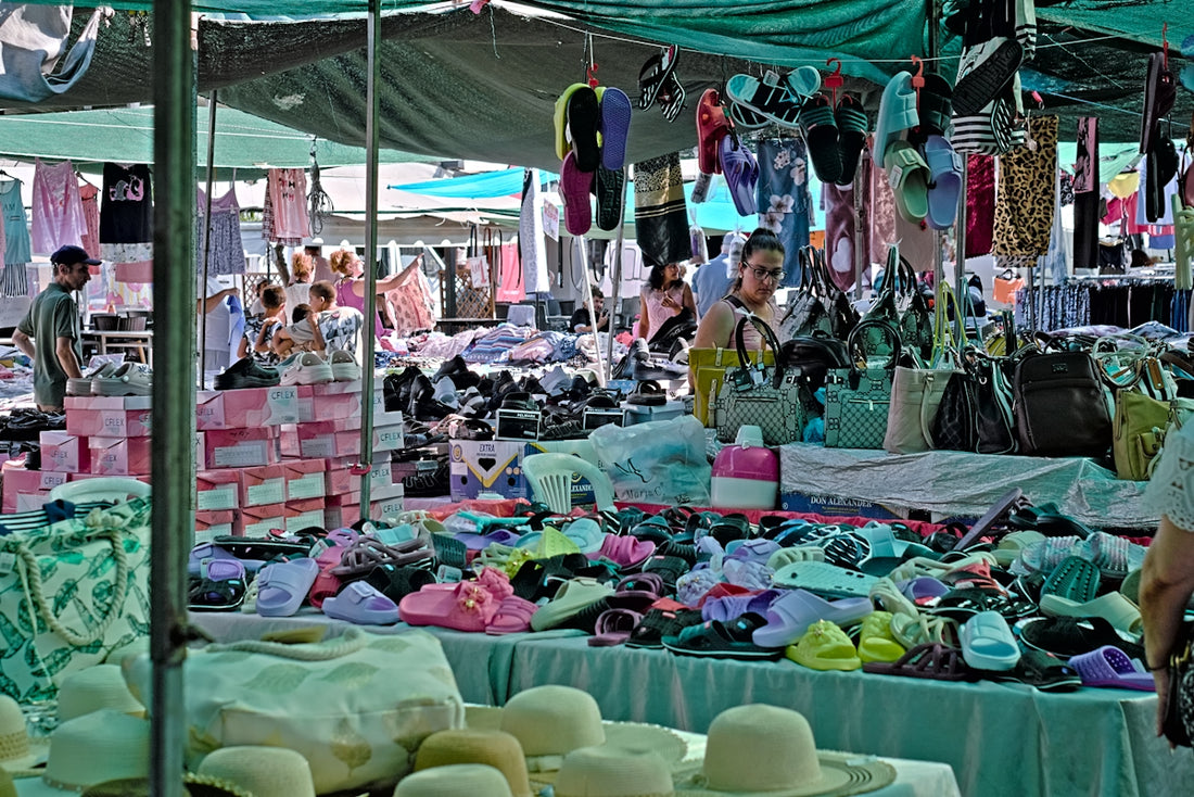 A bustling market stall offers various items for sale.